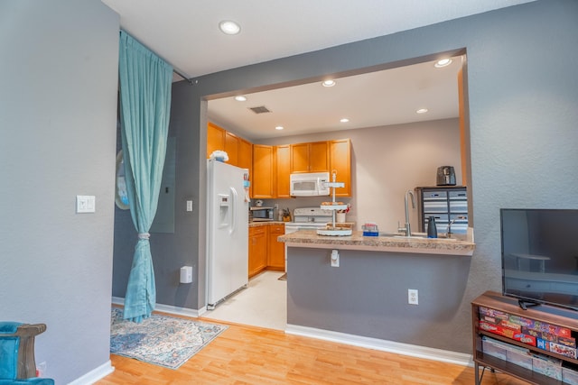 161 Lake Monterey Cir, Boynton Beach, FL 33426 - kitchen featuring white appliances, a peninsula, light countertops, recessed lighting, and light wood finished floors