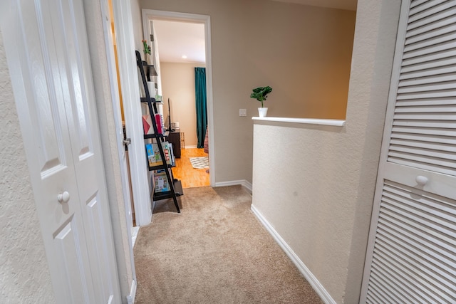 161 Lake Monterey Cir, Boynton Beach, FL 33426 - corridor featuring carpet flooring, a textured wall, and an upstairs landing