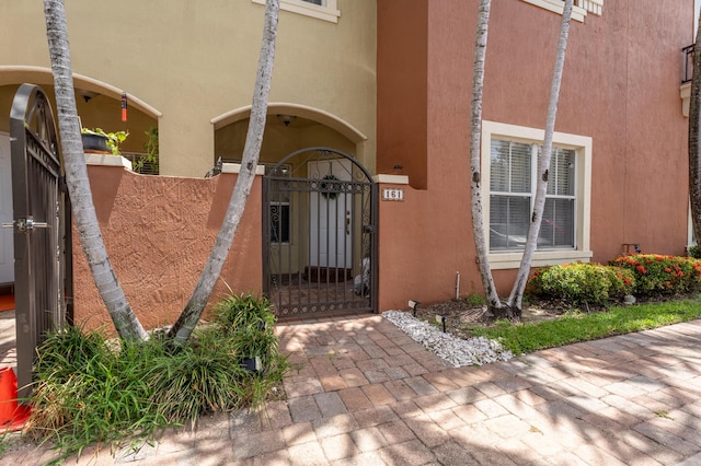 161 Lake Monterey Cir, Boynton Beach, FL 33426 - entrance to property with a gate and stucco siding