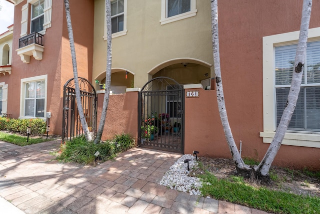 161 Lake Monterey Cir, Boynton Beach, FL 33426 - view of exterior entry featuring a gate and stucco siding