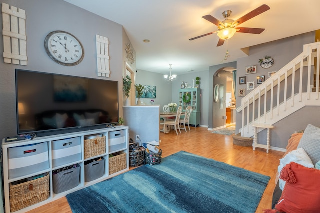 161 Lake Monterey Cir, Boynton Beach, FL 33426 - living area with stairway, arched walkways, ceiling fan, wood finished floors, and a chandelier