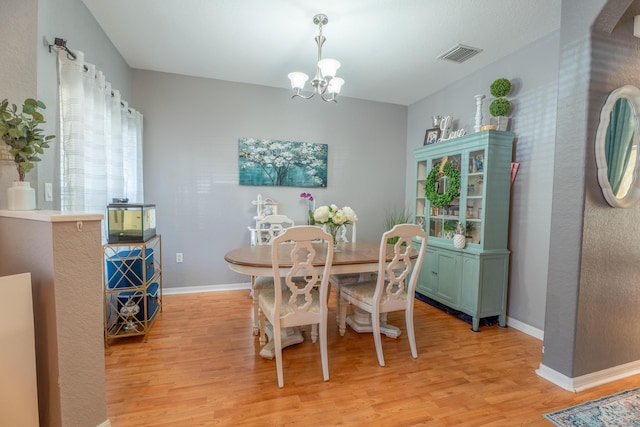 161 Lake Monterey Cir, Boynton Beach, FL 33426 - dining room featuring light wood-style flooring and a chandelier