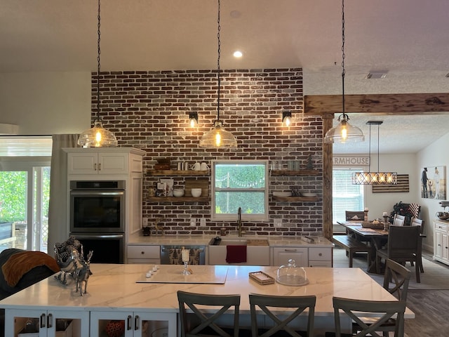 2457 SE Shipping Rd, Port Saint Lucie, FL 34952 - dining area featuring brick wall and wood finished floors