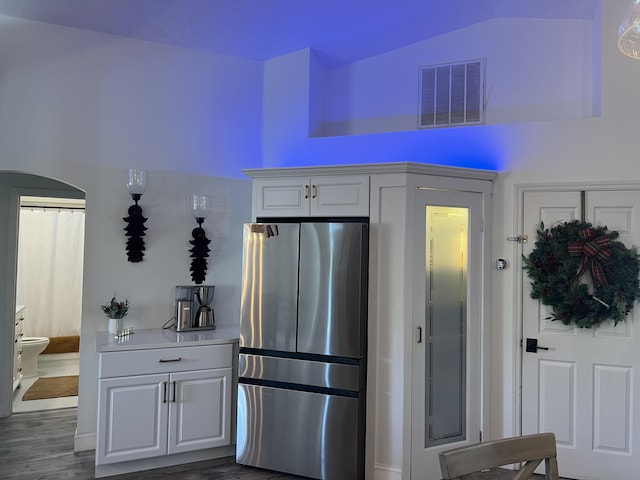 2457 SE Shipping Rd, Port Saint Lucie, FL 34952 - kitchen featuring freestanding refrigerator, white cabinetry, lofted ceiling, dark wood finished floors, and light countertops