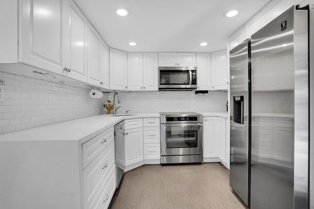 8291 Thames Blvd Unit C, Boca Raton, FL 33433 - kitchen featuring appliances with stainless steel finishes, light countertops, white cabinetry, recessed lighting, and tasteful backsplash