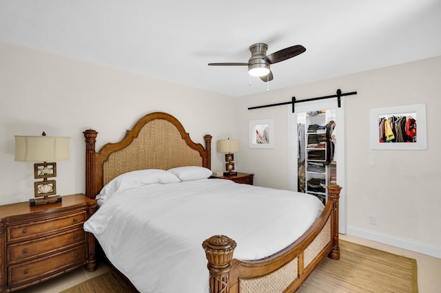8291 Thames Blvd Unit C, Boca Raton, FL 33433 - bedroom featuring a barn door, a spacious closet, a closet, and a ceiling fan