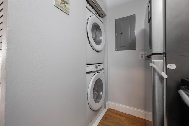 624 Sea Pine Way Unit A2, Greenacres, FL 33415 - washroom with electric panel, stacked washing machine and dryer, and wood finished floors