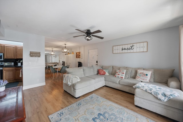 624 Sea Pine Way Unit A2, Greenacres, FL 33415 - living room with ceiling fan, light wood finished floors, and a chandelier