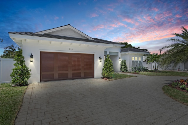 737 Nighthawk Way, North Palm Beach, FL 33408 - view of front of home with decorative driveway, stucco siding, a garage, and a tiled roof