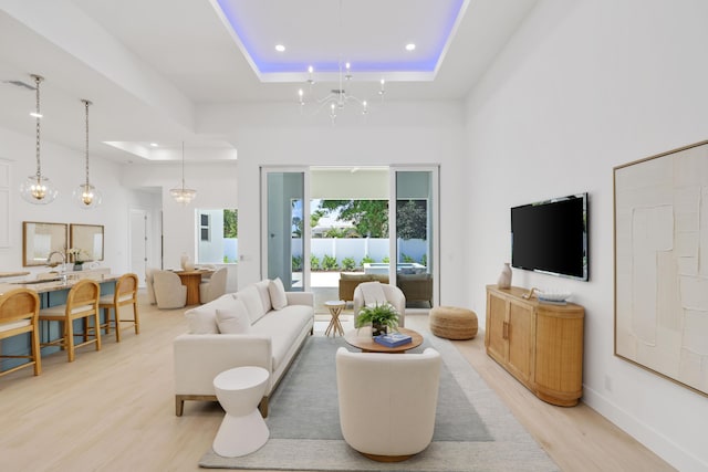 737 Nighthawk Way, North Palm Beach, FL 33408 - living room with a raised ceiling, light wood-type flooring, recessed lighting, a chandelier, and a towering ceiling