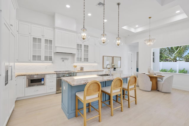 737 Nighthawk Way, North Palm Beach, FL 33408 - kitchen featuring appliances with stainless steel finishes, white cabinetry, light wood-type flooring, backsplash, and recessed lighting