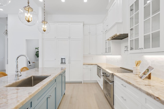 737 Nighthawk Way, North Palm Beach, FL 33408 - kitchen with high end stainless steel range, blue cabinets, white cabinets, light wood-style flooring, and recessed lighting