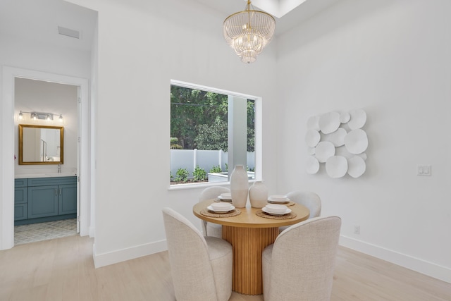 737 Nighthawk Way, North Palm Beach, FL 33408 - dining room with a chandelier and light wood-style floors