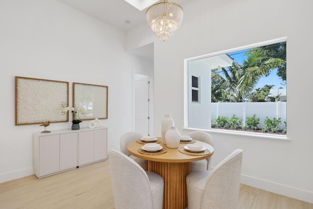 737 Nighthawk Way, North Palm Beach, FL 33408 - dining area with healthy amount of natural light, a chandelier, and light wood finished floors