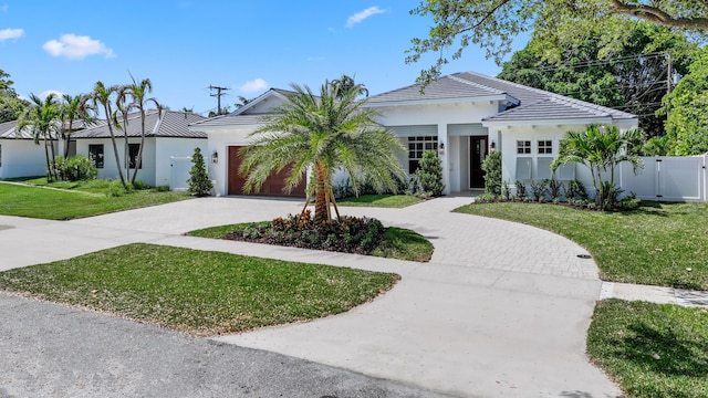 737 Nighthawk Way, North Palm Beach, FL 33408 - view of front facade with concrete driveway, a garage, and stucco siding
