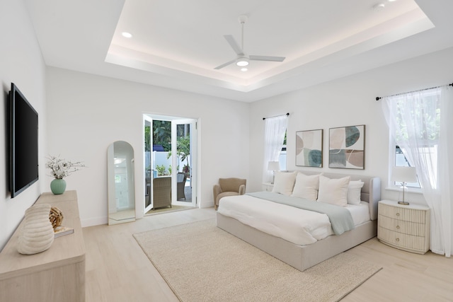 737 Nighthawk Way, North Palm Beach, FL 33408 - bedroom with a raised ceiling, recessed lighting, access to outside, light wood-type flooring, and a ceiling fan