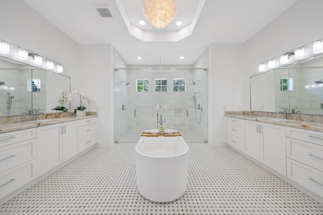 737 Nighthawk Way, North Palm Beach, FL 33408 - full bath with a shower stall, two vanities, a freestanding tub, and recessed lighting