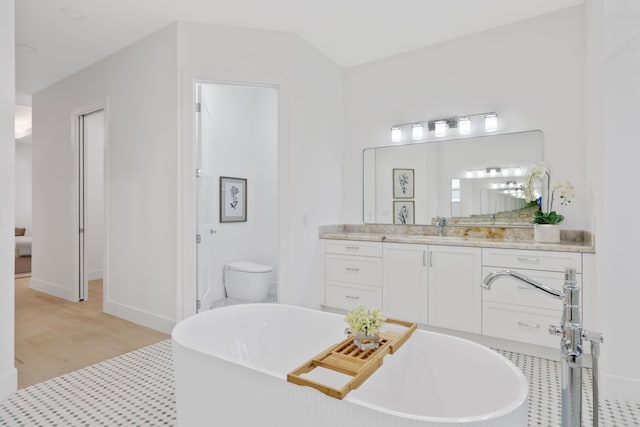 737 Nighthawk Way, North Palm Beach, FL 33408 - bathroom featuring a freestanding bath, vanity, and wood finished floors