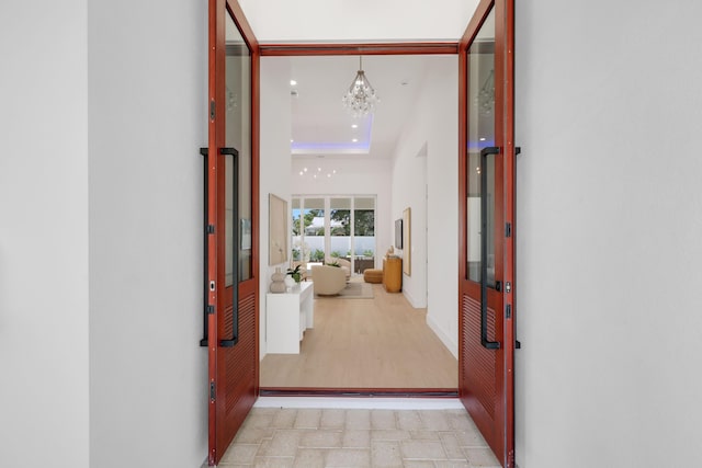 737 Nighthawk Way, North Palm Beach, FL 33408 - hall featuring a chandelier