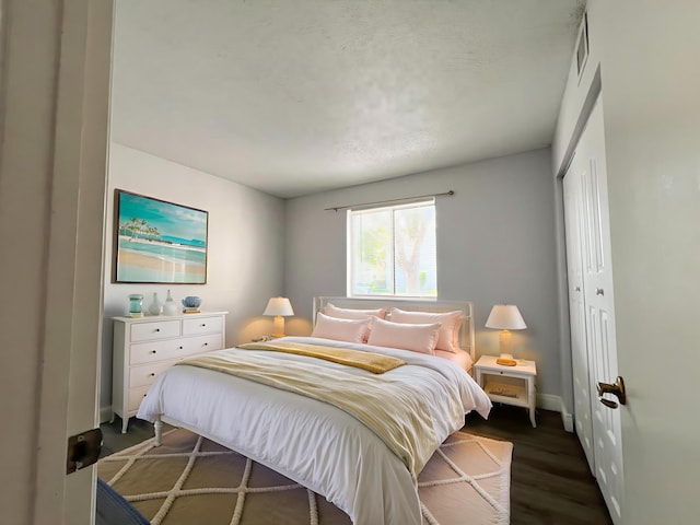 717 Gardens Dr Unit 106, Pompano Beach, FL 33069 - bedroom with a closet and dark wood-style floors