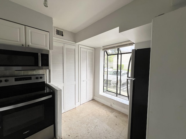 717 Gardens Dr Unit 106, Pompano Beach, FL 33069 - kitchen featuring stainless steel appliances and white cabinetry
