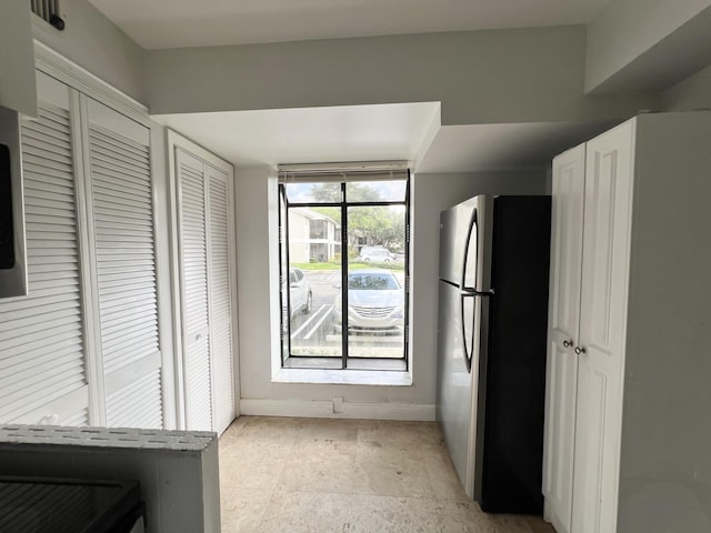 717 Gardens Dr Unit 106, Pompano Beach, FL 33069 - kitchen with freestanding refrigerator and baseboards
