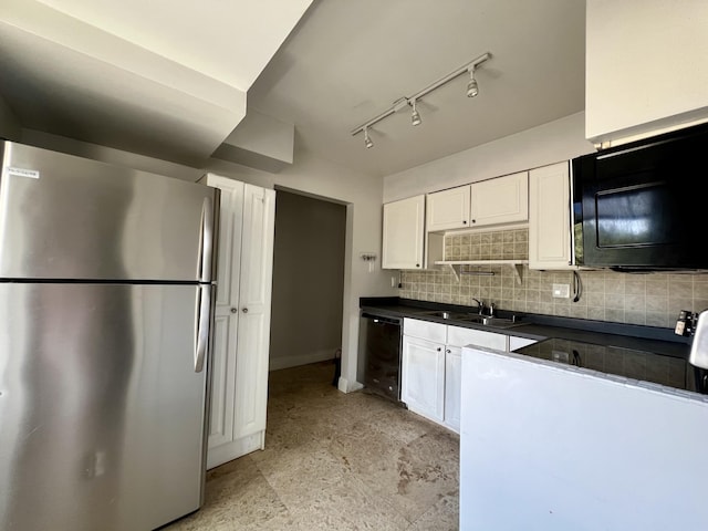 717 Gardens Dr Unit 106, Pompano Beach, FL 33069 - kitchen featuring black appliances, dark countertops, white cabinetry, tasteful backsplash, and track lighting