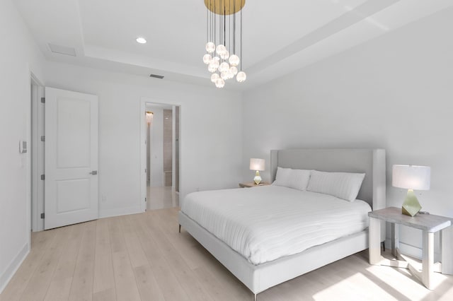 13214 Artisan Cir, Palm Beach Gardens, FL 33418 - bedroom with a raised ceiling, light wood finished floors, recessed lighting, and a chandelier