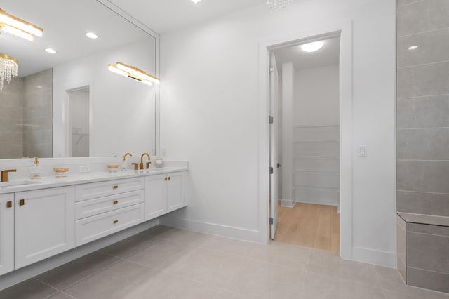 13214 Artisan Cir, Palm Beach Gardens, FL 33418 - bathroom with double vanity, a spacious closet, tile patterned flooring, and recessed lighting