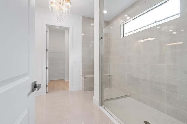 13214 Artisan Cir, Palm Beach Gardens, FL 33418 - bathroom featuring a shower stall, tile patterned floors, and a chandelier