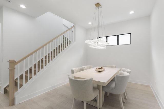 13214 Artisan Cir, Palm Beach Gardens, FL 33418 - dining space featuring stairway, recessed lighting, wood finished floors, and a chandelier