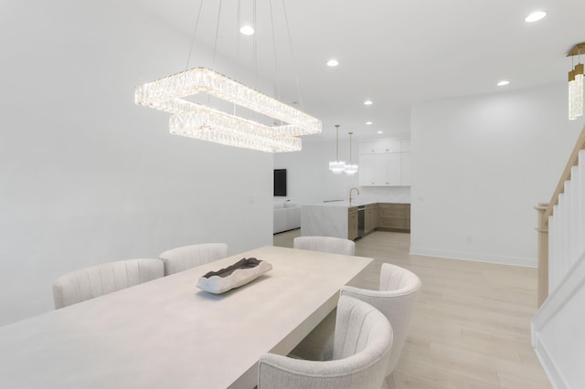 13214 Artisan Cir, Palm Beach Gardens, FL 33418 - dining space with a chandelier, light wood finished floors, recessed lighting, and stairway