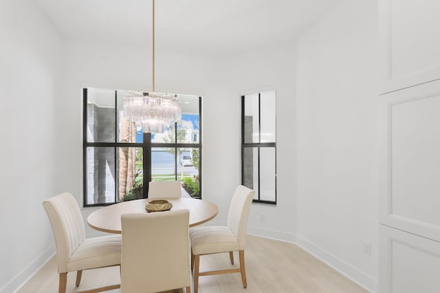 13214 Artisan Cir, Palm Beach Gardens, FL 33418 - dining room featuring a chandelier and light wood-style floors