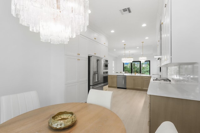 13214 Artisan Cir, Palm Beach Gardens, FL 33418 - dining room featuring a chandelier, recessed lighting, light wood-style flooring, and radiator
