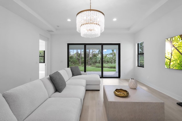 13214 Artisan Cir, Palm Beach Gardens, FL 33418 - living area featuring a raised ceiling, plenty of natural light, a chandelier, and recessed lighting