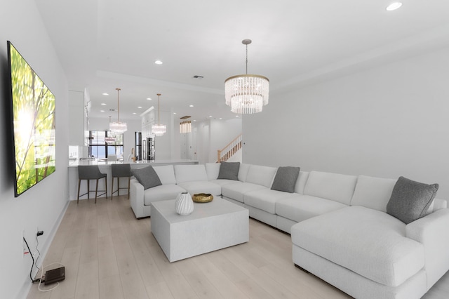 13214 Artisan Cir, Palm Beach Gardens, FL 33418 - living room with a chandelier, recessed lighting, light wood finished floors, and stairway