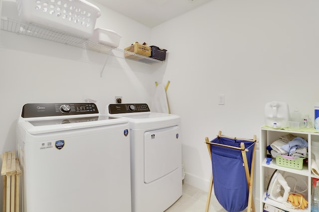 1416 Gopher Ter, Stuart, FL 34994 - washroom with washing machine and clothes dryer and light tile patterned floors