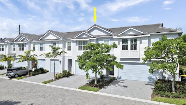 1416 Gopher Ter, Stuart, FL 34994 - view of property featuring a garage, a tile roof, and driveway
