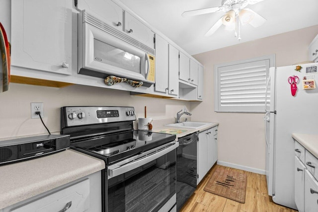 7376 W Oakridge Cir Unit C4320, Lake Worth, FL 33462 - kitchen featuring white appliances, light countertops, light wood-style flooring, and white cabinetry