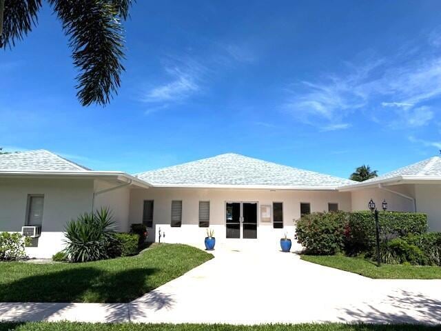 7376 W Oakridge Cir Unit C4320, Lake Worth, FL 33462 - rear view of house with stucco siding and a yard