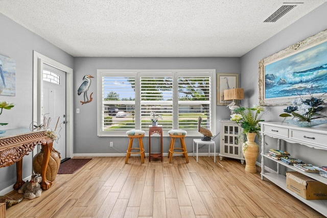 7376 W Oakridge Cir Unit C4320, Lake Worth, FL 33462 - dining area featuring light wood-style floors and a textured ceiling