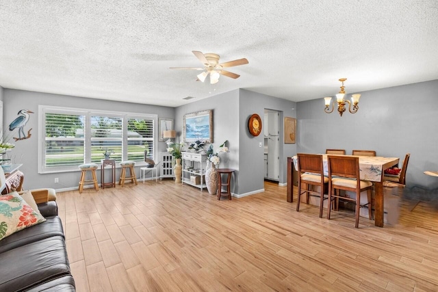 7376 W Oakridge Cir Unit C4320, Lake Worth, FL 33462 - living area with light wood-style flooring, a chandelier, a ceiling fan, and a textured ceiling