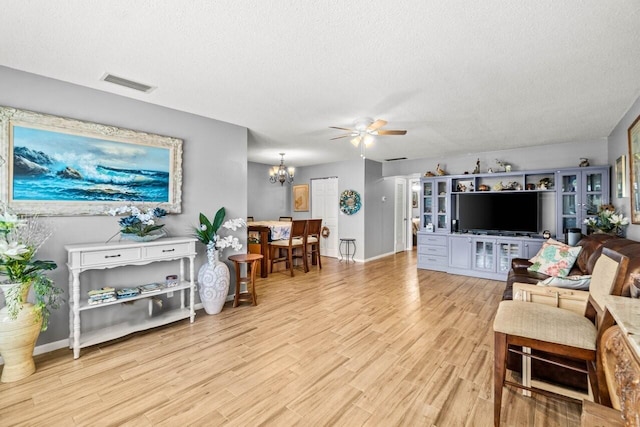 7376 W Oakridge Cir Unit C4320, Lake Worth, FL 33462 - living room with ceiling fan, light wood finished floors, a textured ceiling, and a chandelier