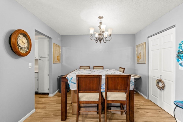 7376 W Oakridge Cir Unit C4320, Lake Worth, FL 33462 - dining space with a chandelier, light wood finished floors, and a textured ceiling