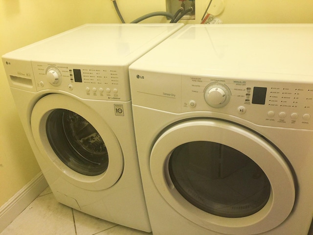 5051 Pointe Emerald Ln Unit 5051, Boca Raton, FL 33486 - laundry area with washing machine and dryer and light tile patterned floors