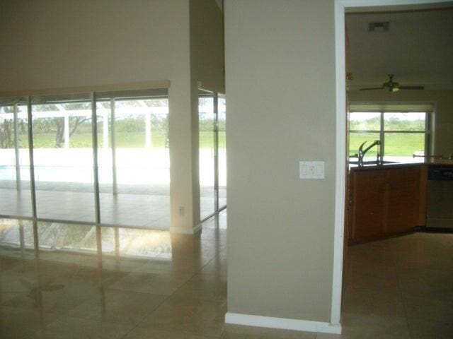 24 Dunbar Rd, Palm Beach Gardens, FL 33418 - corridor featuring tile patterned flooring