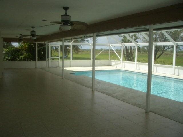 24 Dunbar Rd, Palm Beach Gardens, FL 33418 - swimming pool featuring a patio area, glass enclosure, and a ceiling fan