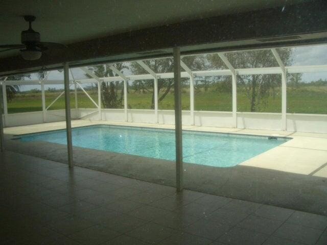 24 Dunbar Rd, Palm Beach Gardens, FL 33418 - outdoor pool with a lanai, a patio, and a ceiling fan