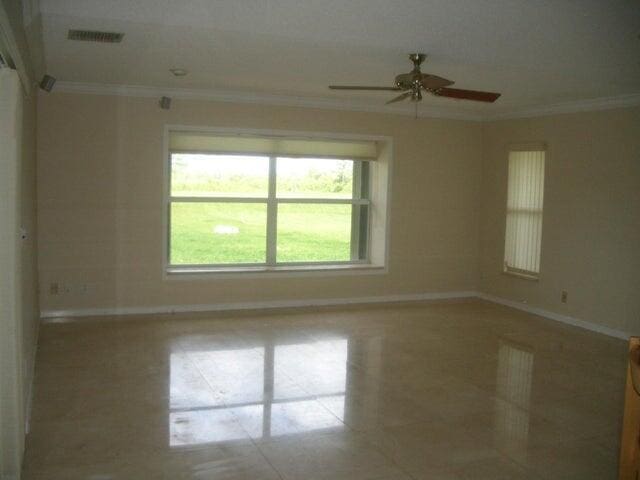 24 Dunbar Rd, Palm Beach Gardens, FL 33418 - unfurnished room featuring crown molding and a ceiling fan