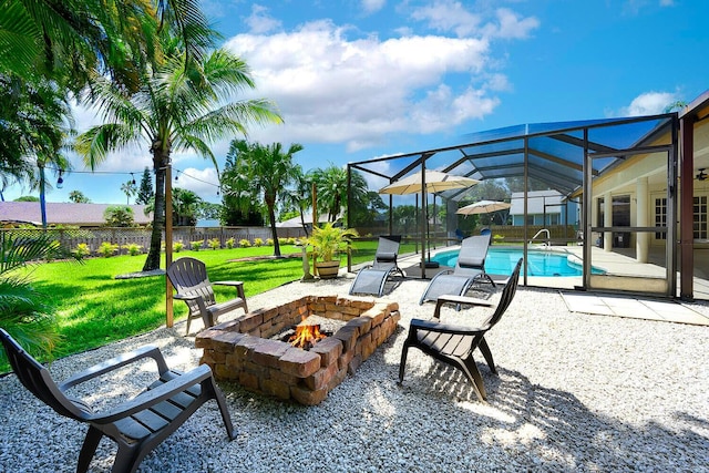 2282 NE Marlberry Ln, Jensen Beach, FL 34957 - fenced backyard with an outdoor fire pit, a patio area, and a lanai